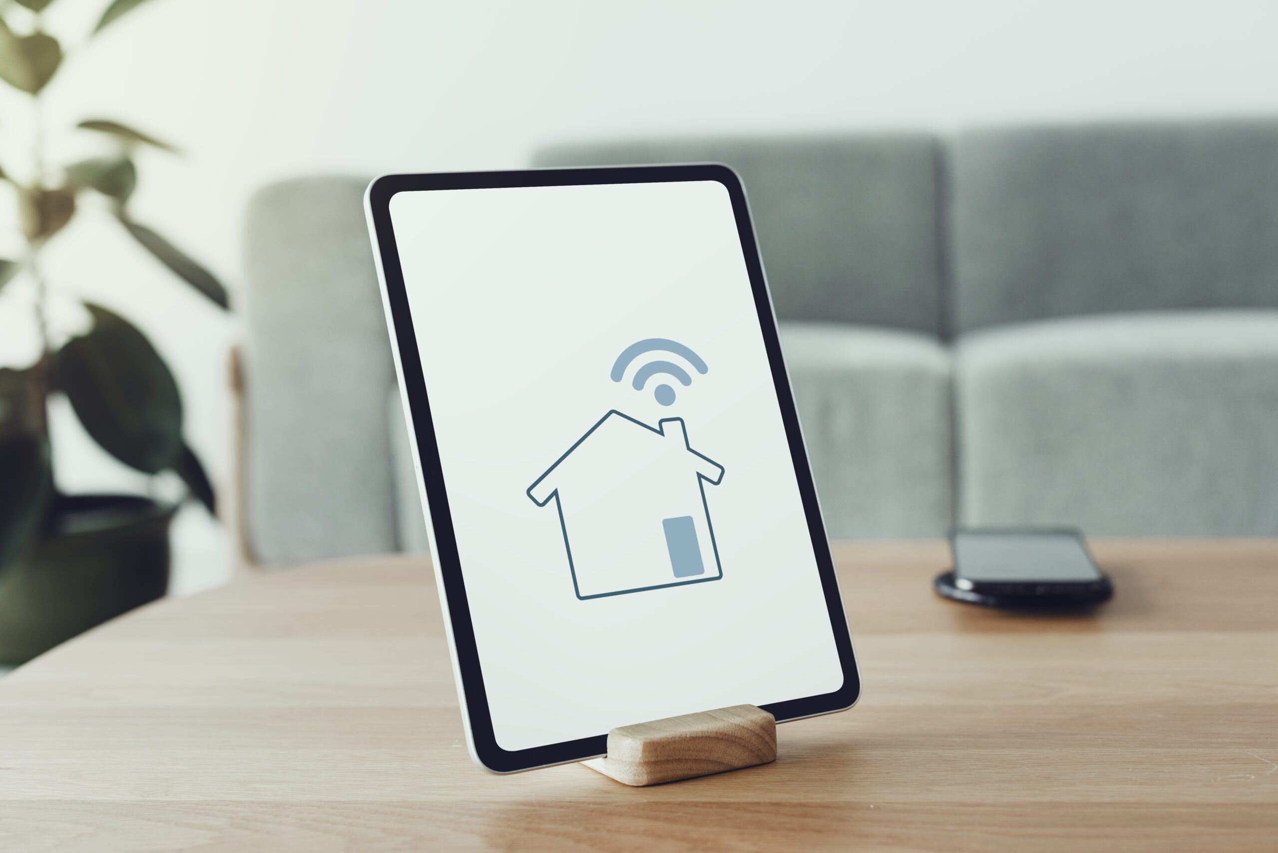 Digital tablet screen with smart home controller on a wooden tab